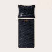A level 1 intensity Shakti Premium Acupressure Mat and Pillow bundle in Shakti Black, branded with the Shakti logo