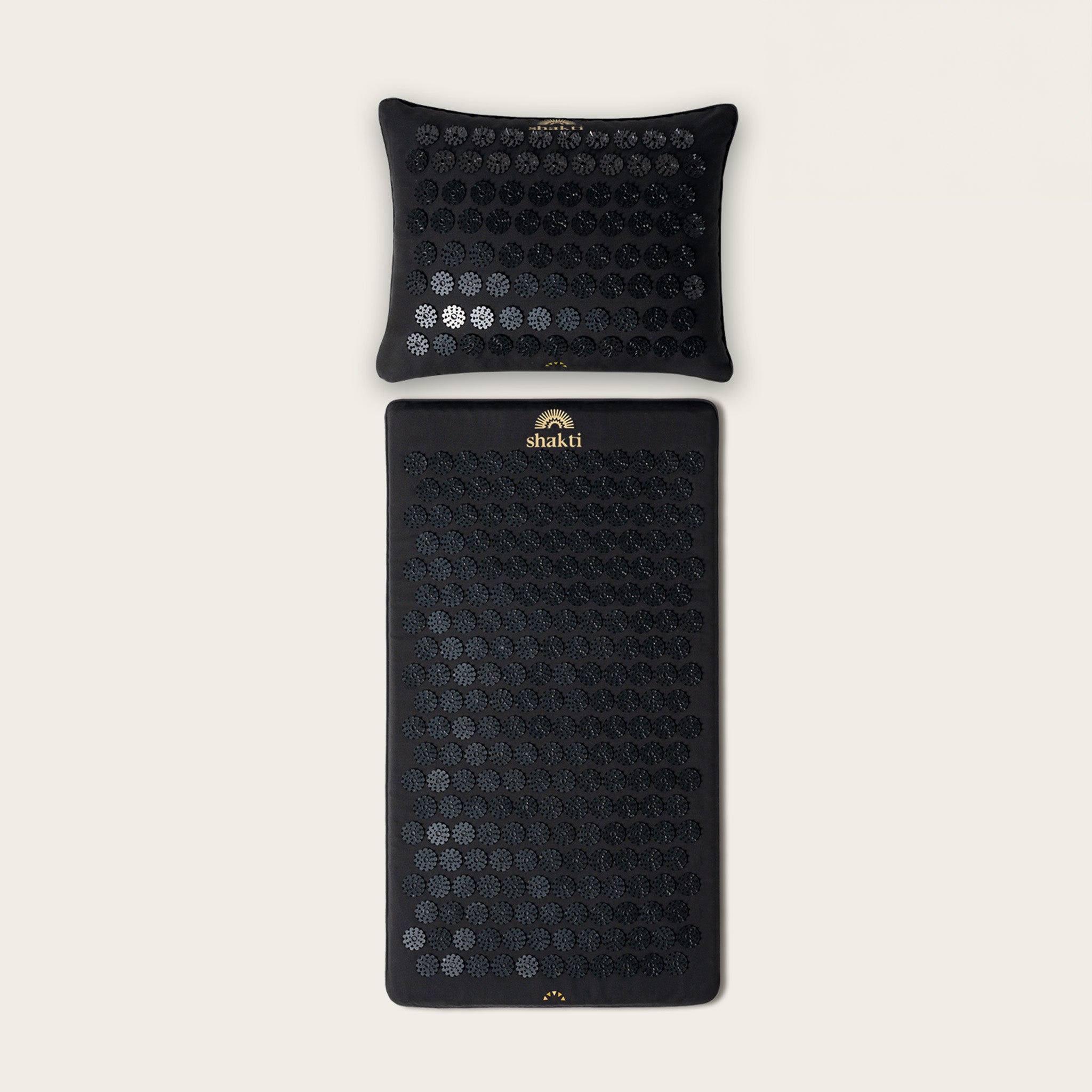 A level 1 intensity Shakti Premium Acupressure Mat and Pillow bundle in Shakti Black, branded with the Shakti logo